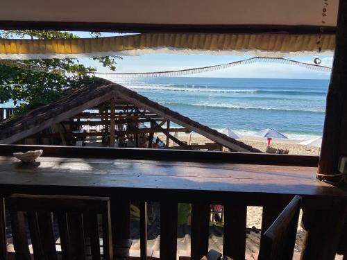 a view of the beach from a balcony at Warung Santai Bali Jimbaran in Uluwatu