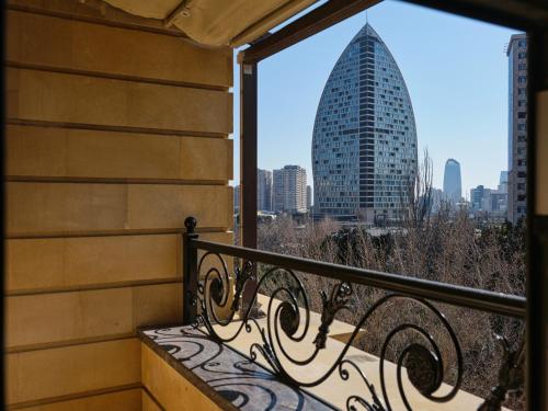 a balcony with a view of a skyscraper at The Central Point Hotel Baku in Baku