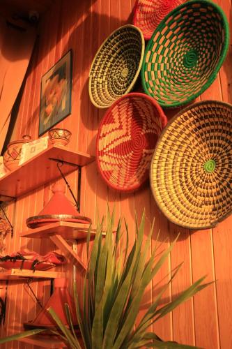 a wall with baskets hanging on a wall at imsouane bleu bay house in Imsouane