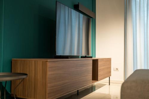 a flat screen tv sitting on top of a wooden dresser at Compagnoni Suite Luxe - Spa & Wellness in Milan