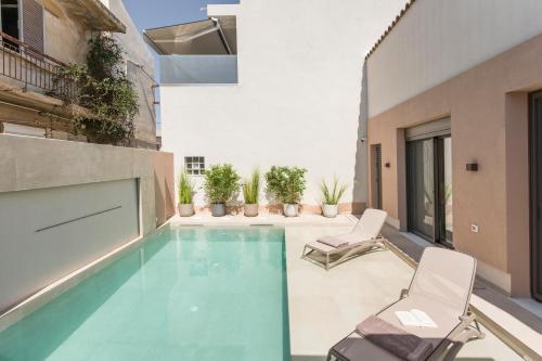 a swimming pool in the middle of a building at Orama Luxury Apartments in Nea Kydonia