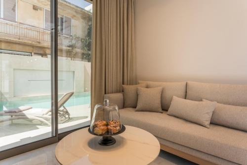 a living room with a couch and a table at Orama Luxury Apartments in Nea Kydonia