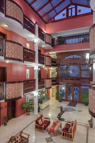 a large lobby with chairs and tables in a building at Chatto Hotel in Tuzla