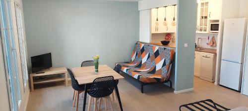 un petit salon avec une table et un canapé dans l'établissement Home near to Paris, aeroport, Eurodisney, à Les Pavillons-sous-Bois