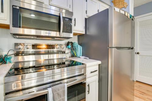 a kitchen with stainless steel appliances and a microwave at 2 Mi to Silver Dollar City Cozy Condo with Balcony! in Branson West