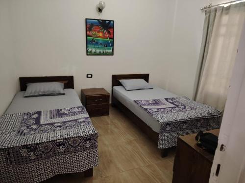 Postel nebo postele na pokoji v ubytování Gardenia House