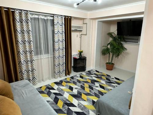 a living room with a checkered floor at Уютный уголок кв 54 in Shymkent