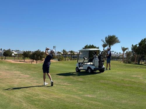 a group of people playing golf on a golf course at Pickalbatros Hôtel Du Golf - Adults Friendly 16 Years Plus- All-Inclusive in Marrakech