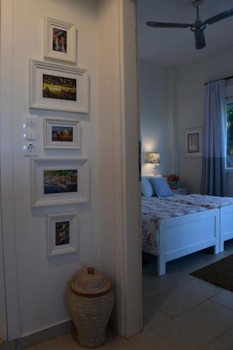 a bedroom with a bed and framed pictures on the wall at Philippos 1 in Diaporos