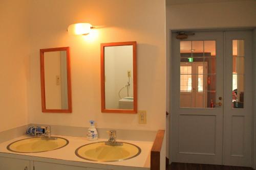 a bathroom with two sinks and two mirrors at Irodorinoyado Kaede Izumi - Vacation STAY 70069v in Yamanakako