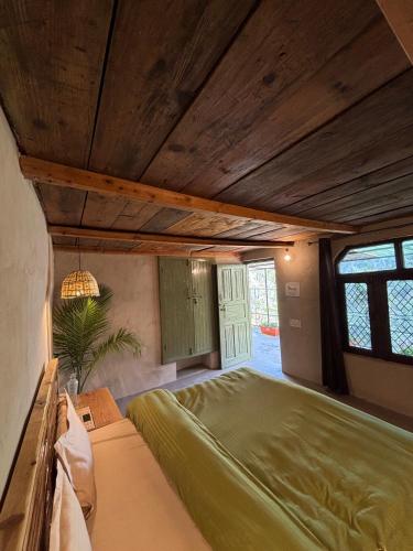 a bedroom with a large bed in a room at #middleofnowehere Pahadi Homestay by Mon Stays in Dhanaulti