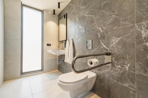 a bathroom with a toilet and a sink at Nos Aqua Villas Chania in Pazinos