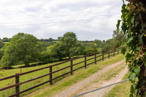 a fence on the side of a field at Welsh Marches at Upper Glyn Farm in Chepstow