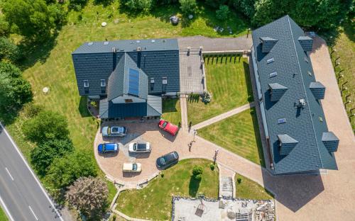 an overhead view of a large house with a parking lot at Apartmán pod Javorovým vrchem in Nebory
