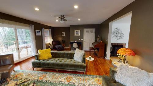 a living room with a couch and a fireplace at Winter Lore in Mendon