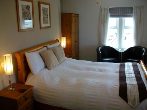Ένα ή περισσότερα κρεβάτια σε δωμάτιο στο Gate Lodge Guest House