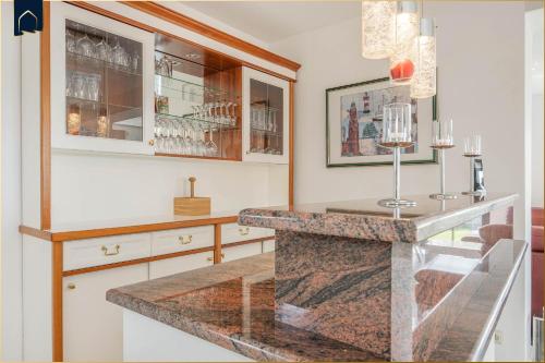 a kitchen with a counter with a glass counter top at Ferienhaus Sonnendeck in Ueckeritz