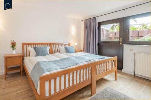 a bedroom with a large bed and a window at Ferienhaus Sonnendeck in Ueckeritz
