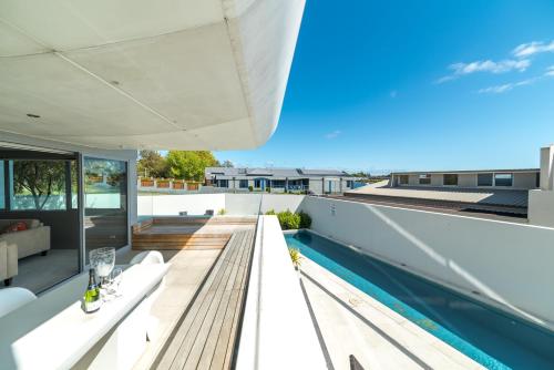 a view from the roof of a house with a swimming pool at Sacred Waters Taupo in Taupo