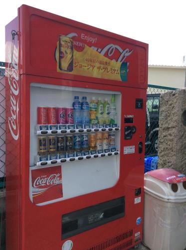 a red soda machine with drinks in it at Kamikatsura House in Kyoto