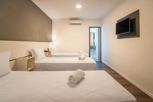 Ένα ή περισσότερα κρεβάτια σε δωμάτιο στο Uniclass Hotel Lapa