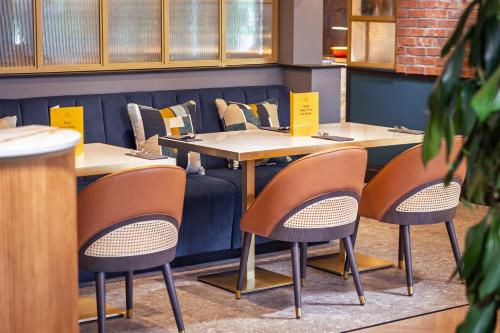 a row of tables and chairs in a restaurant at voco Fareham - Solent by IHG in Fareham