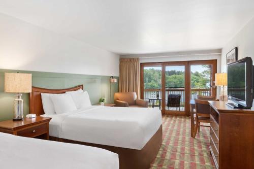 a hotel room with two beds and a television at Ocean Gate Resort in Southport