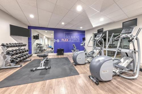 a gym with several treadmills and tread machines at Holiday Inn Express & Suites Moore by IHG in Moore