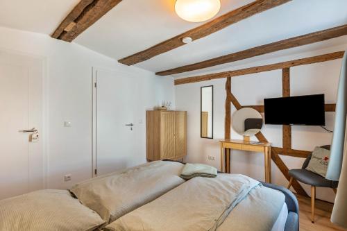 a bedroom with a bed and a tv in it at Zeihäänger Stubb in Schwalmstadt