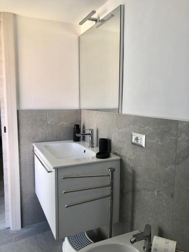 a bathroom with a sink and a mirror at La Ballerina Bianca - romantica vista lago in Bellano