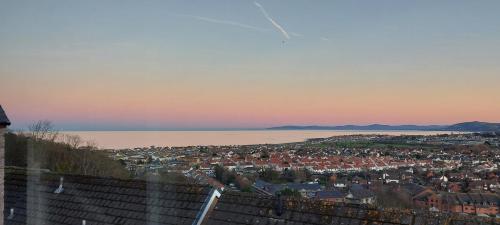 a city with a view of a town and the water at Detached with Amazing Sea Views and Hot Tub in Llandudno
