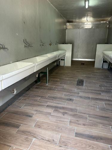 an empty bathroom with two sinks and two benches at Camping BellaVista in Bolzano Novarese