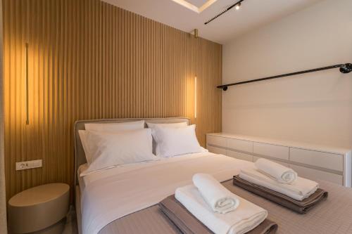 a bedroom with a bed with two towels on it at Orama Luxury Apartments in Nea Kydonia