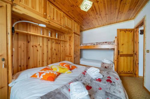 a bedroom with two beds in a wooden cabin at Casa Margherita - Valbruna in Valbruna