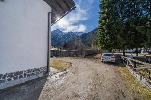 a car parked on a dirt road with mountains in the background at Casa Margherita - Valbruna in Valbruna