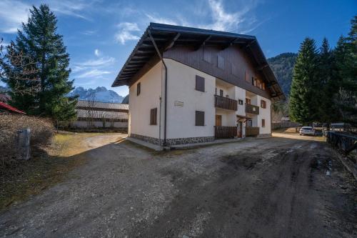 a large white building on a dirt road at Casa Margherita - Valbruna in Valbruna