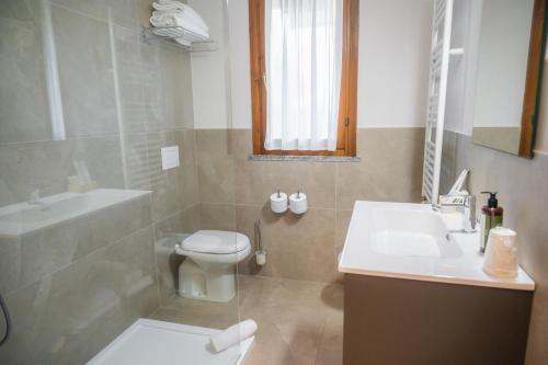 a bathroom with a toilet and a sink at Ulivi Hotel & Residence in Paratico