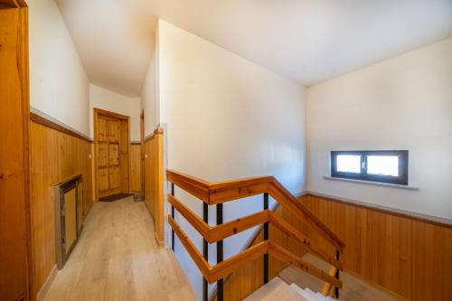 a room with a staircase and a window at Casa Margherita - Valbruna in Valbruna