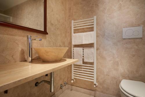 a bathroom with a sink and a bowl on a counter at B&B Le Stanze del Duomo in Florence
