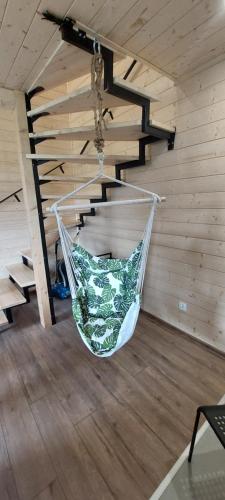 a hammock hanging from a ceiling in a room at Domek przy Młynie Koło Wodne in Krościenko