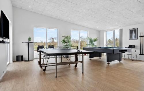 a room with two ping pong tables and two pool tables at Nice Home In Højslev With Sauna in Højslev