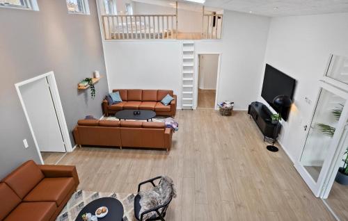 a living room with a couch and a tv at Nice Home In Højslev With Sauna in Højslev
