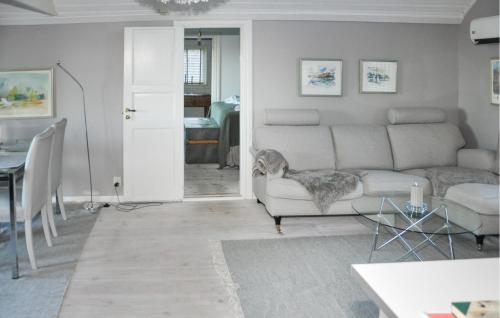 a living room with a couch and a table at 3 Bedroom Amazing Home In Strängnäs in Strängnäs