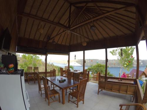 a dining room with a table and chairs at Sakti OceanView Nusa Penida in Nusa Penida