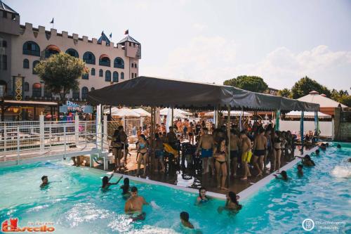 a large group of people in a swimming pool at Il Castello di Perano in Perano