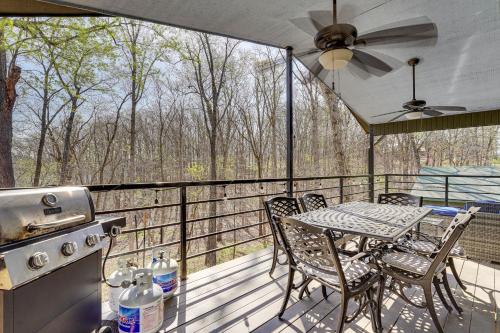 a screened in porch with a table and a stove at Table Rock Lake Home with Lake Access and Views in Golden