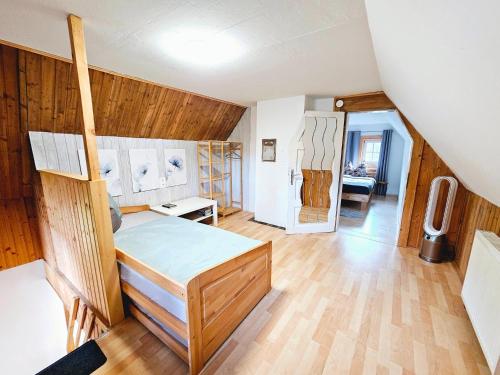 a bedroom with a bed in a room with wooden walls at Beim Michl in Mauthnereck in Krumbach