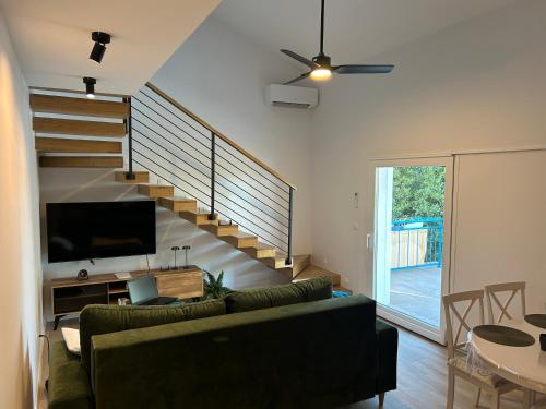 a living room with a couch and a staircase at Casa Liliana By the Sea in Mali Lošinj
