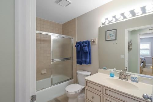 a bathroom with a toilet and a sink and a shower at Updated 2BR Siesta Key condo with private beach access in Siesta Key