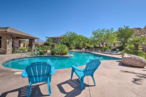 two blue chairs sitting next to a swimming pool at 25 Mi to Zion Rock n Roll Condo with Mtn View! in Hurricane